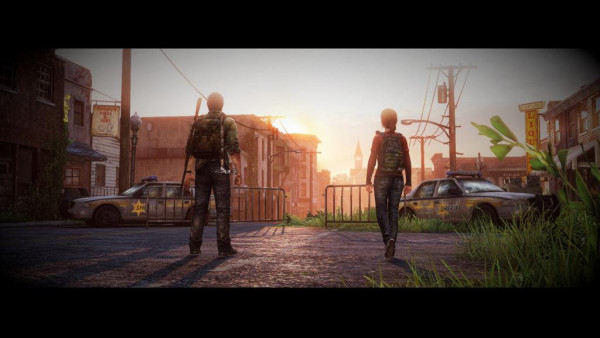 Ellie and Joel walk towards the sunset through an abandoned town in The Last of Us.